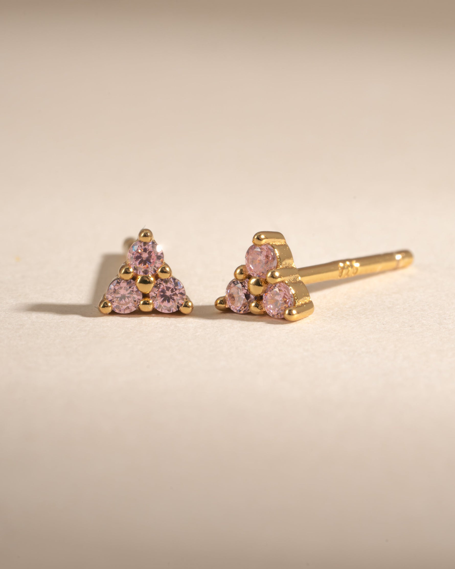 Pink three-stone gold earrings with tiny rose accents, Sami Jewels 3-stone stud earrings for a delicate, elegant look.