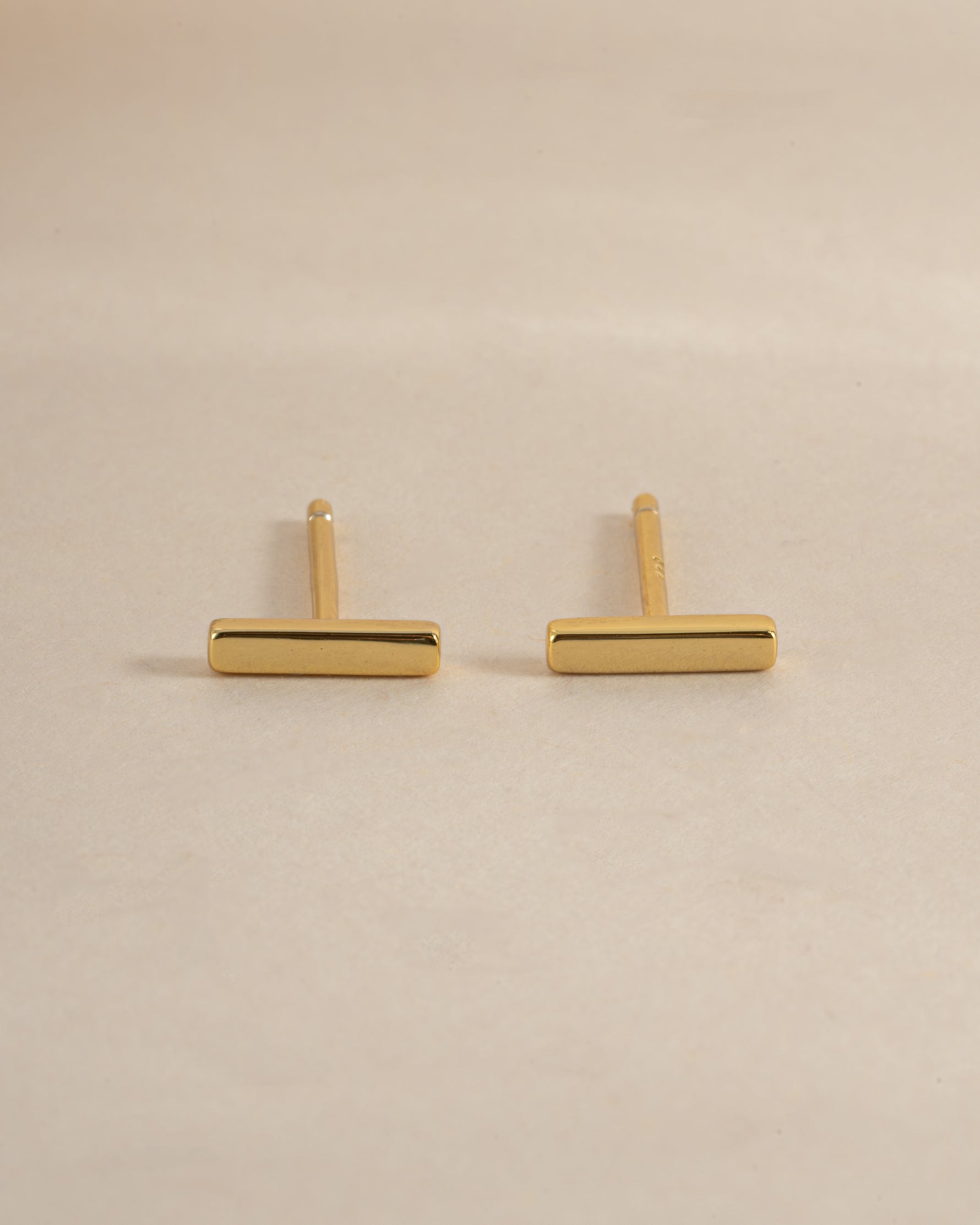 Gold plain bar stud earrings from Sami Jewels, side view showcasing sleek, minimalist design and secure post backing.
