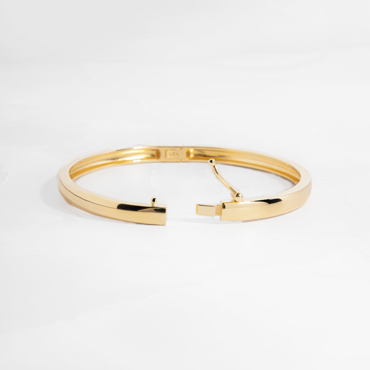 Gold bangle with latch closure