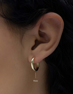 plain huggie hoop earring in gold in 9mm on model
