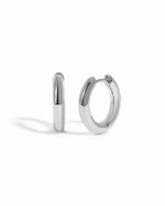 plain minimalist huggie hoops in sterling silver in 10mm on a white background
