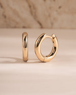 plain huggie hoop earring in gold in 9mm side view
