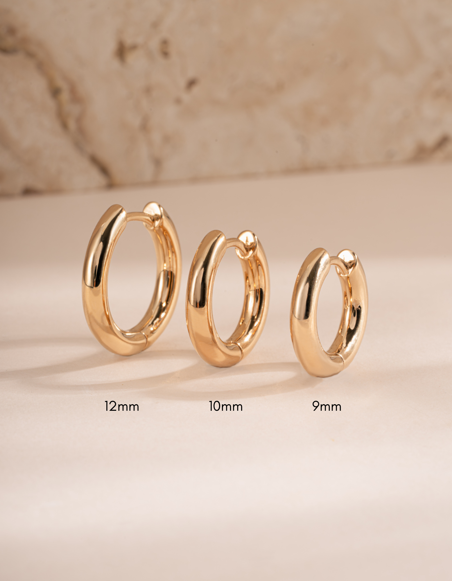 plain huggie hoop earring in various sizes featuring a 9mm plain huggie hoop, 10mm plain huggie, and a 12mm plain huggie