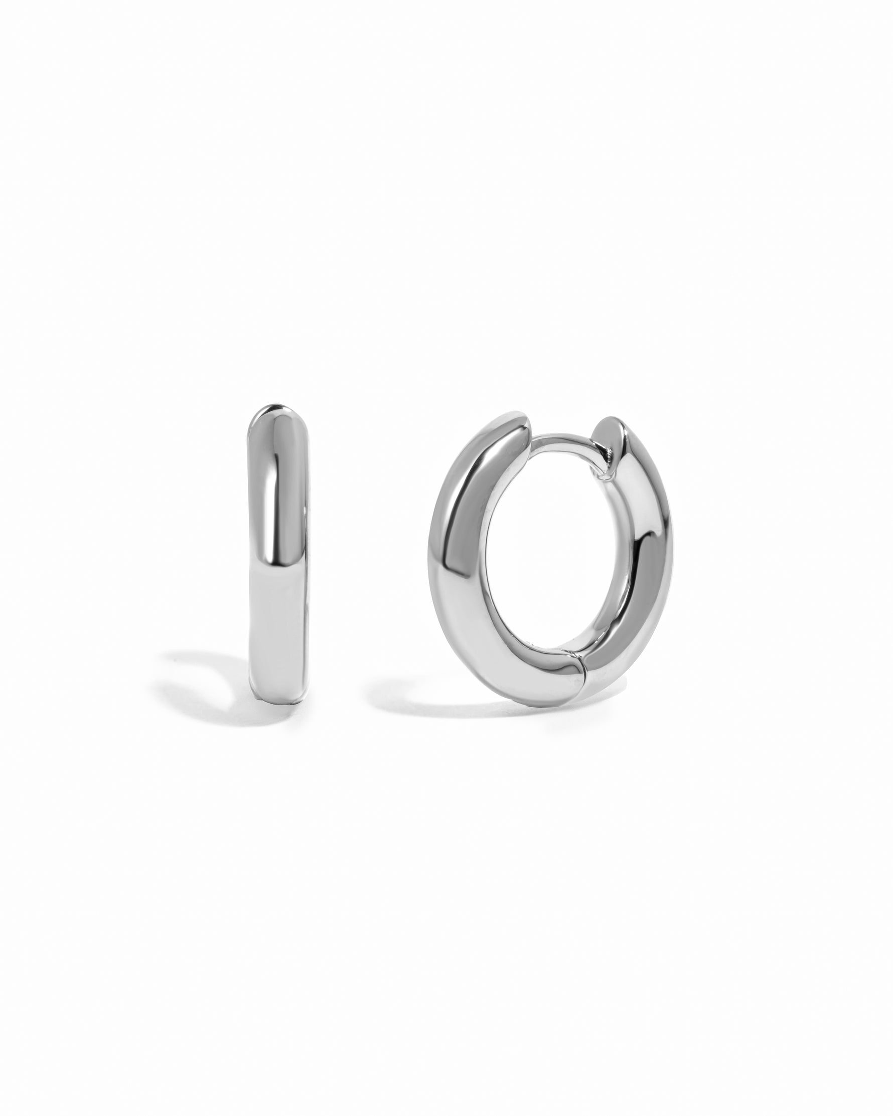 plain huggie hoop earring in sterling silver on a white background