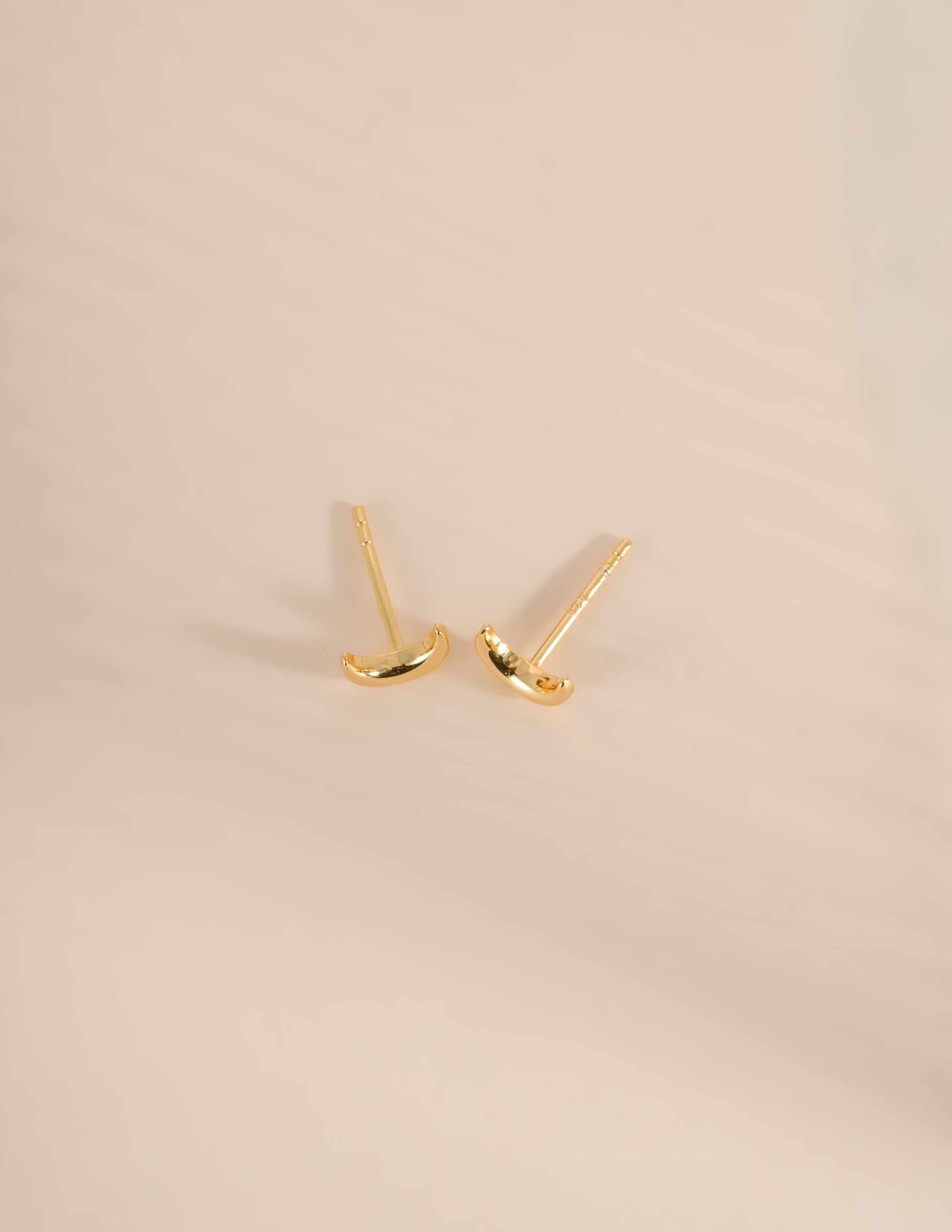 Gold plain moon stud earrings by Sami Jewels, side view showing simple round moon-shaped design.