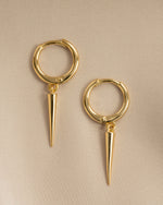Close-up of gold plain spike huggies earrings by Sami Jewels, showing their minimalist design and secure hinge closure.