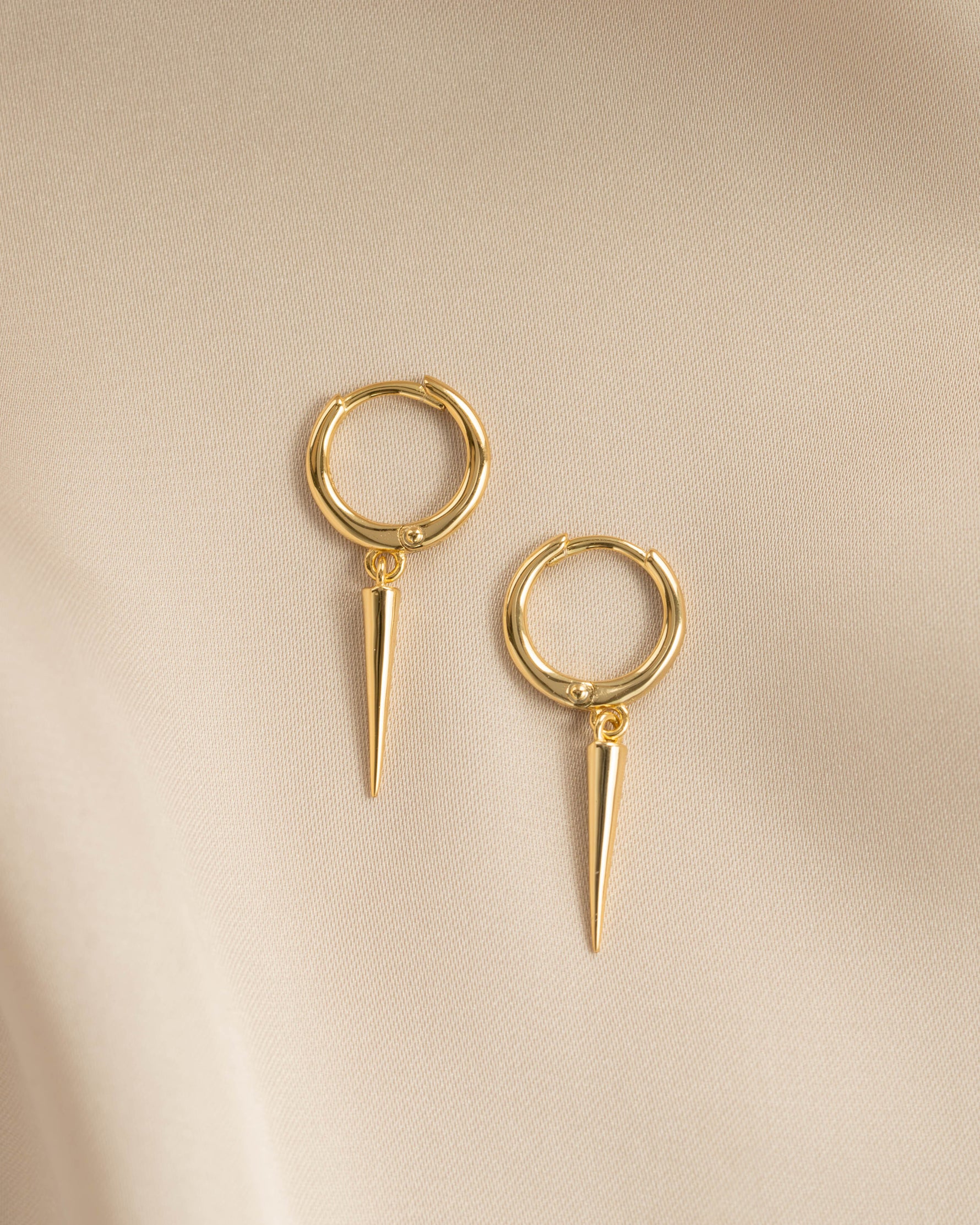 Gold plain spike huggie earrings by Sami Jewels, close-up view showing simple and sleek jewelry design.