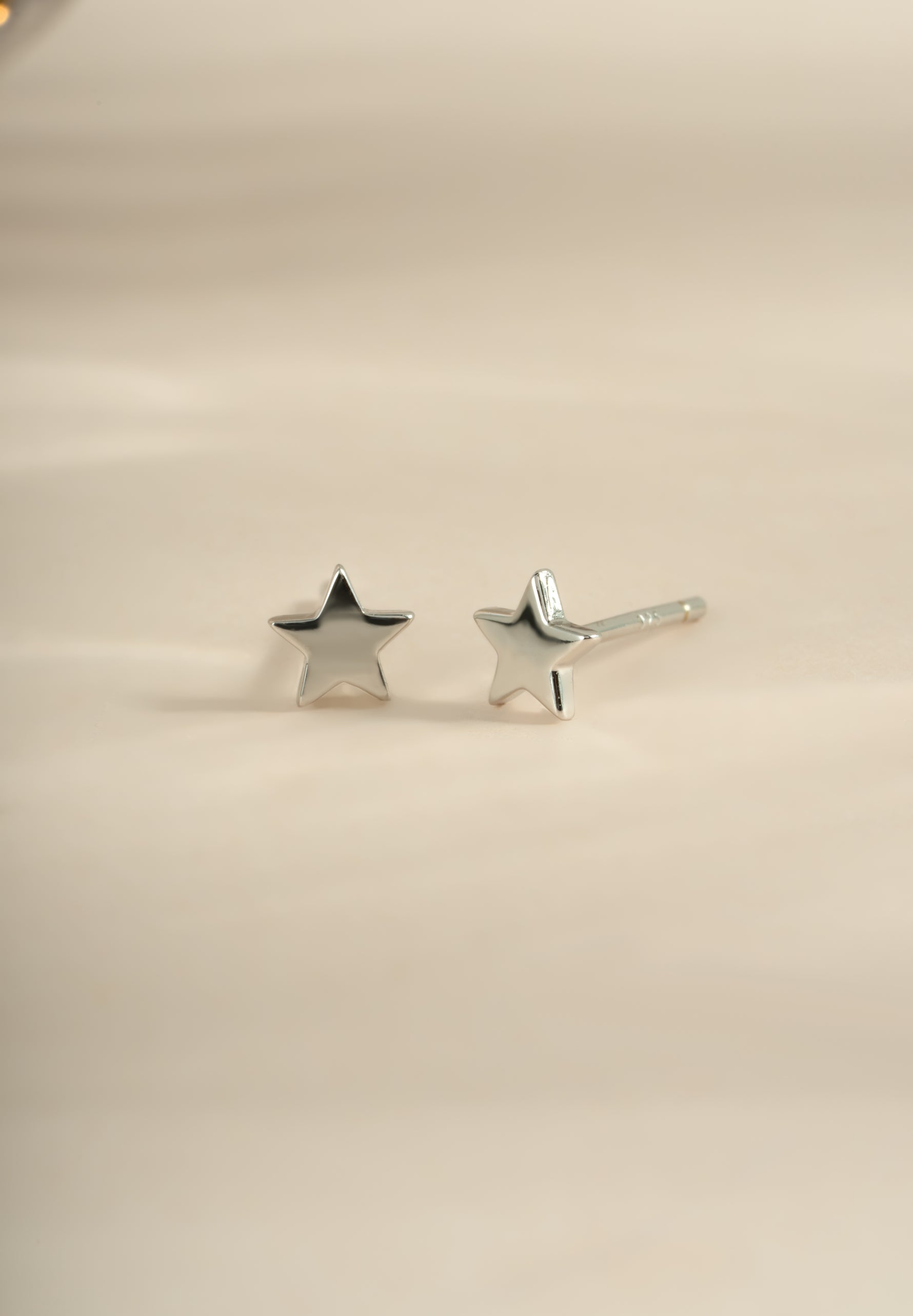 Sterling silver plain star stud earrings by Sami Jewels, small and minimalist star-shaped jewelry for pierced ears.
