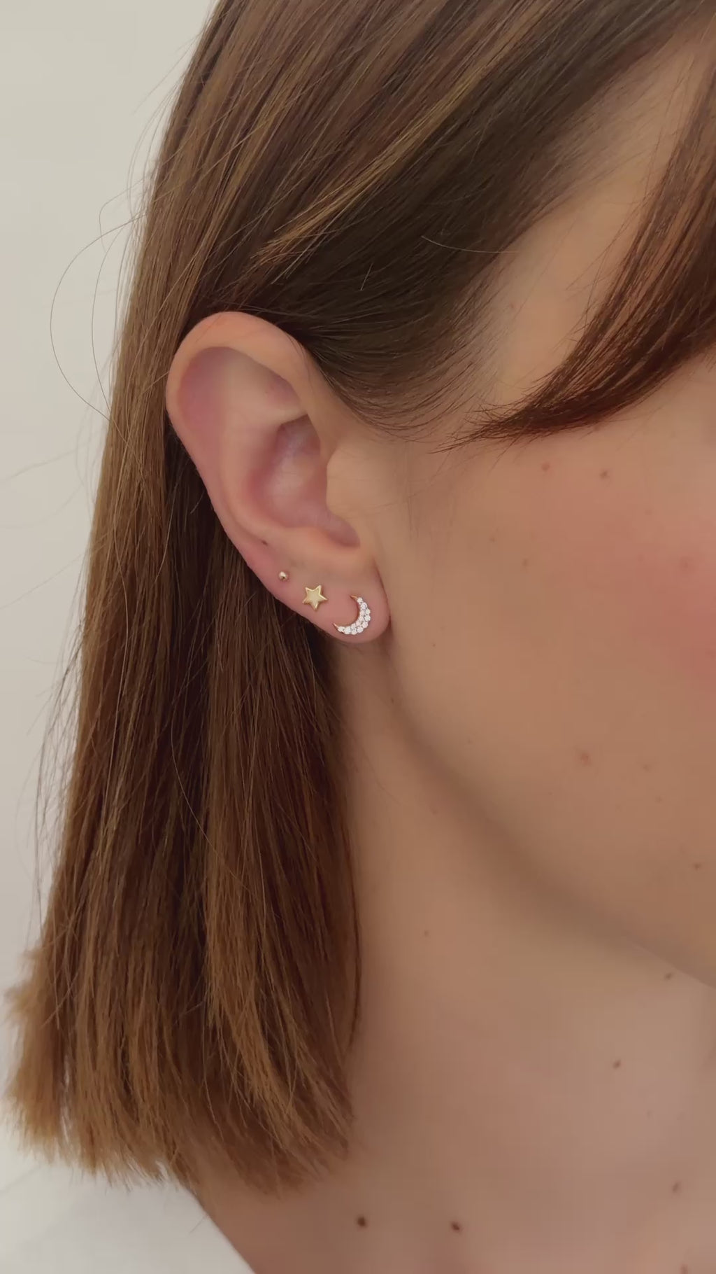 studded moon earrings in gold on model video
