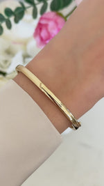 solid bangle bracelet in gold on model