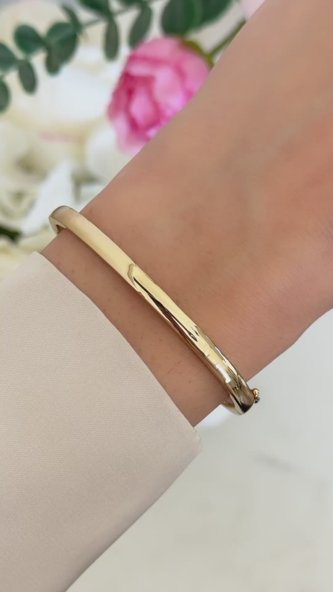 solid bangle bracelet in gold on model