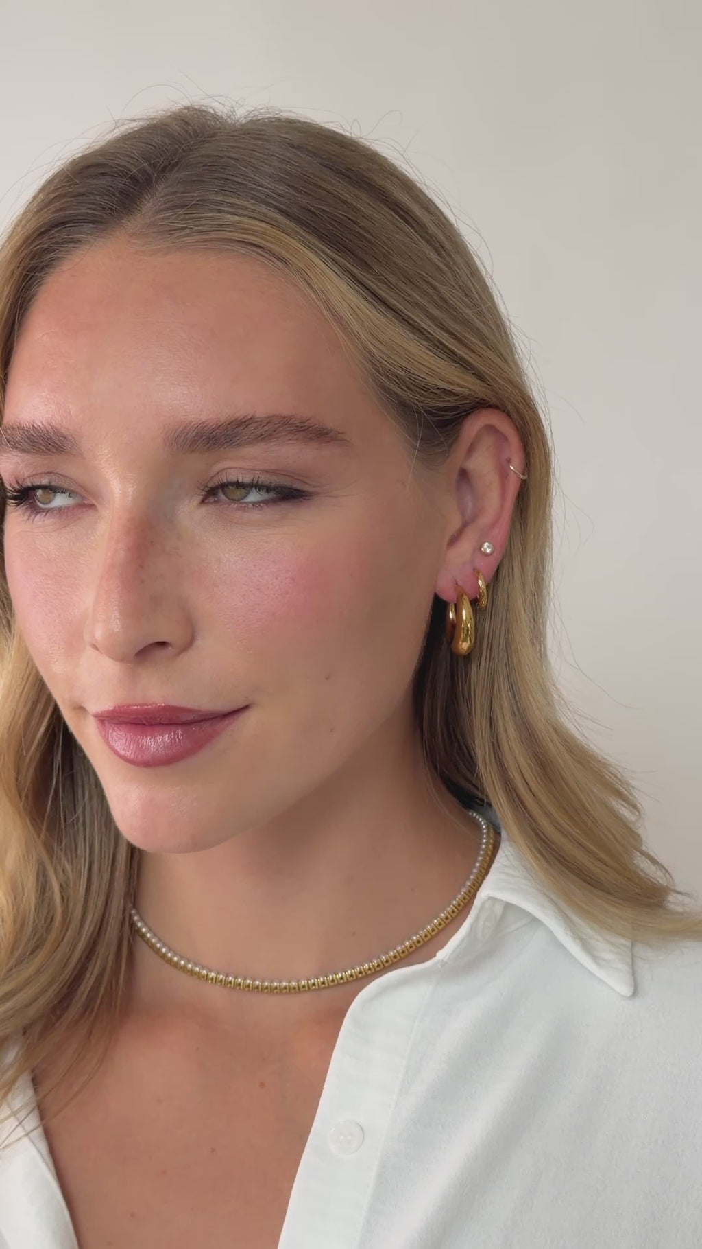 chunky crescent hoop earring stack in gold stainless steel on models ear video
