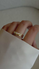 Video of model wearing gold stacking wavy ring set with 5 cz stones.