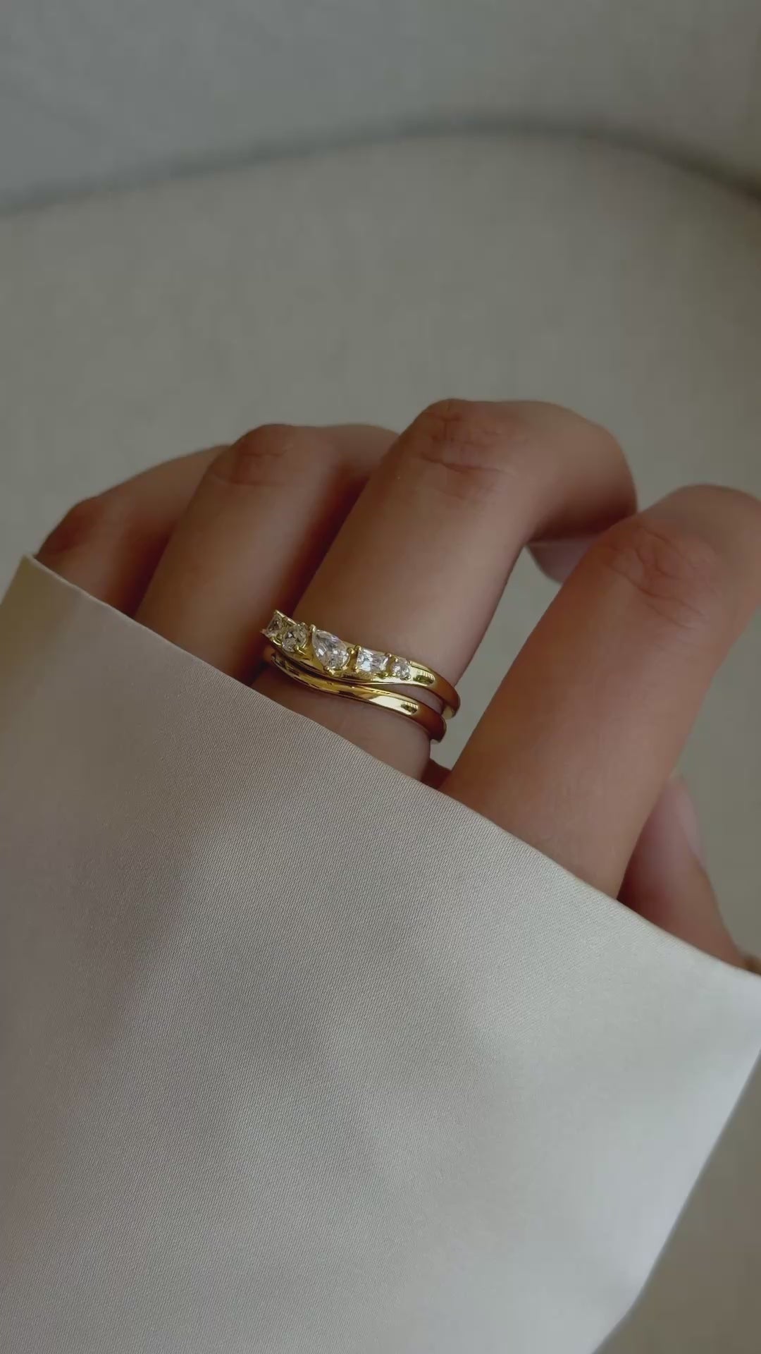 Video of model wearing gold stacking wavy ring set with 5 cz stones.