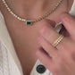 Model wearing emerald cz tennis necklace with gold rings from Sami Jewels