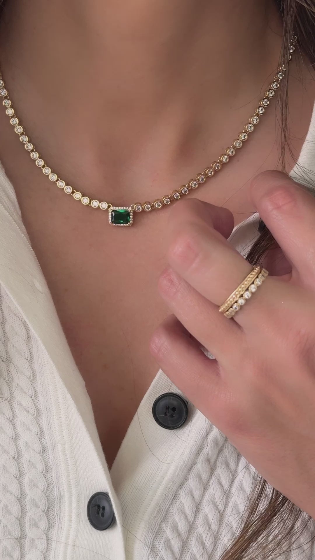 Model wearing emerald cz tennis necklace with gold rings from Sami Jewels