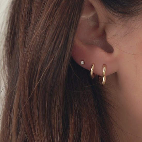 Video showing heart shaped gold hoop earrings