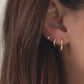 Video showing heart shaped gold hoop earrings