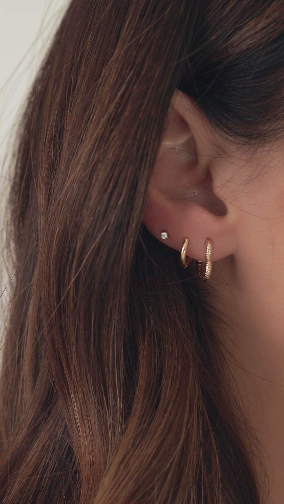 Video showing heart shaped gold hoop earrings