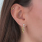 video of model wearing tennis chain bridal jewelry, blending dainty gold hanging earrings with helix earrings.