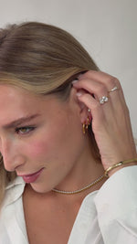 hinged hoop earrings in gold stainless steel on a model