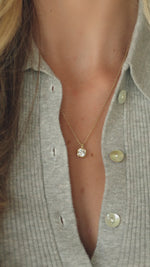 Model wearing gold pendant necklace