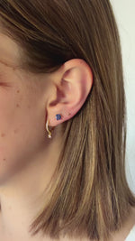 Pave cham huggie earrings in gold on model
