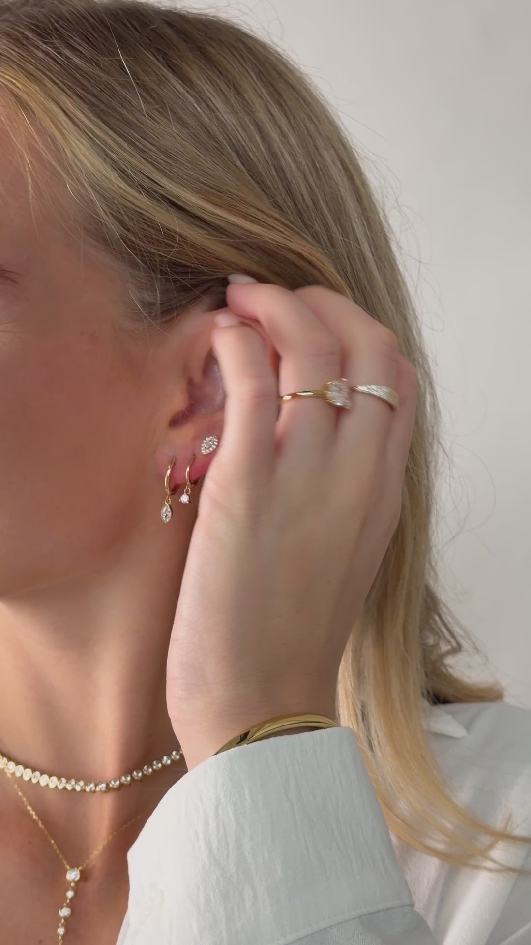 marquise bezel drop huggie earrings in gold on model video
