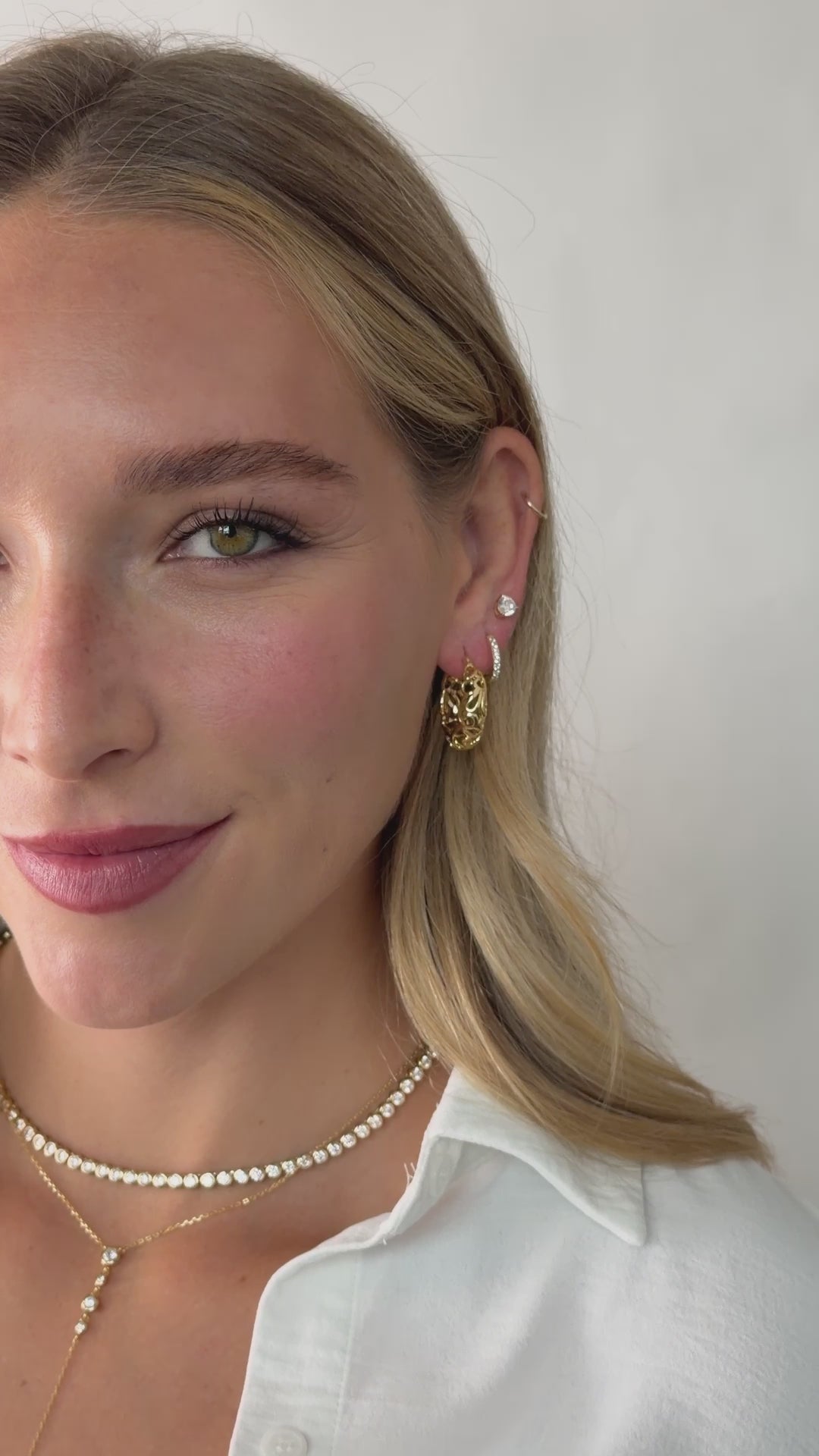 filigree styled hoop earrings in gold on models ear video 