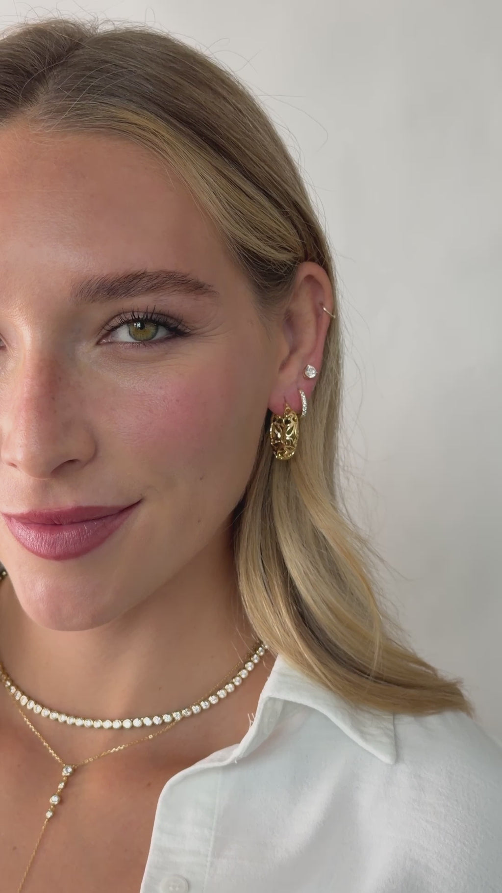 filigree styled hoop earrings in gold on models ear video 