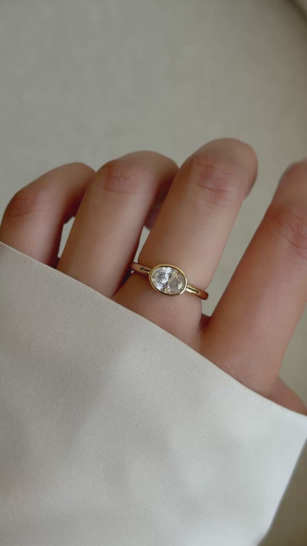 a hand modeling an oval bezel ring