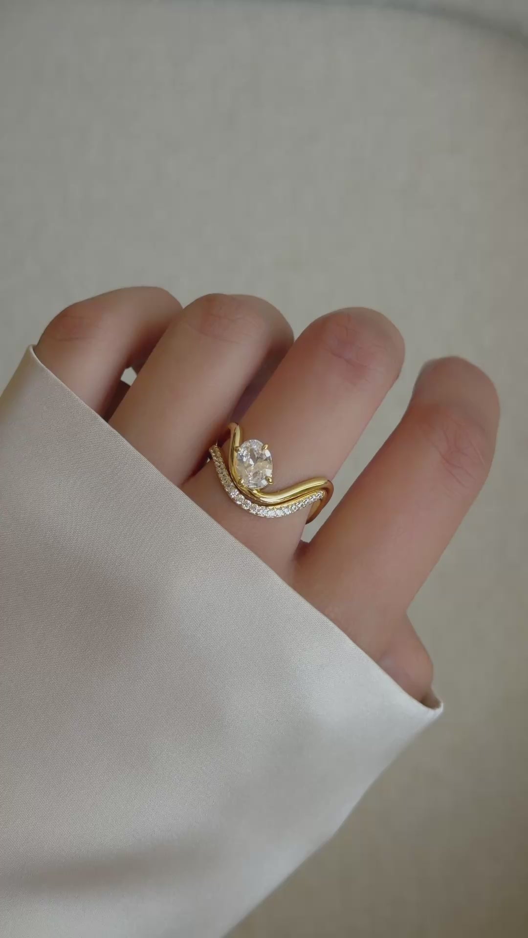 Video of model wearing gold cz oval diamond statement ring set. 