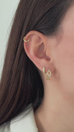 small chain link huggie hoops styled in gold on model video 