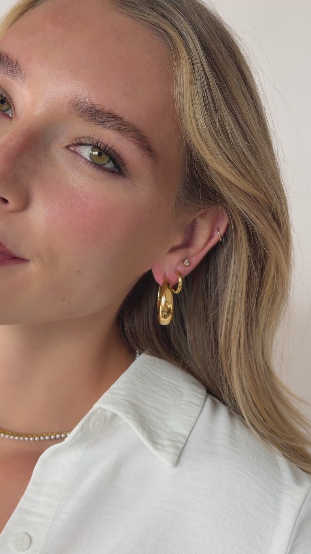 chunky hoop earrings in gold stainless steel on model