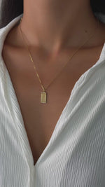 palm tree medallion necklace on a model