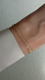 paperclip chain bracelet set in gold on model