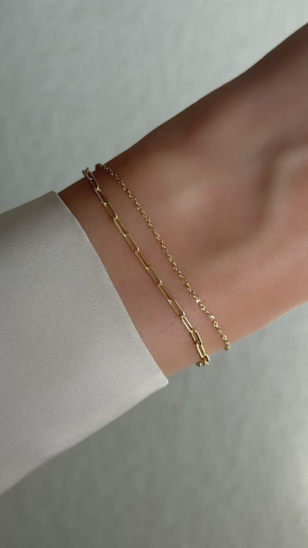 paperclip chain bracelet set in gold on model
