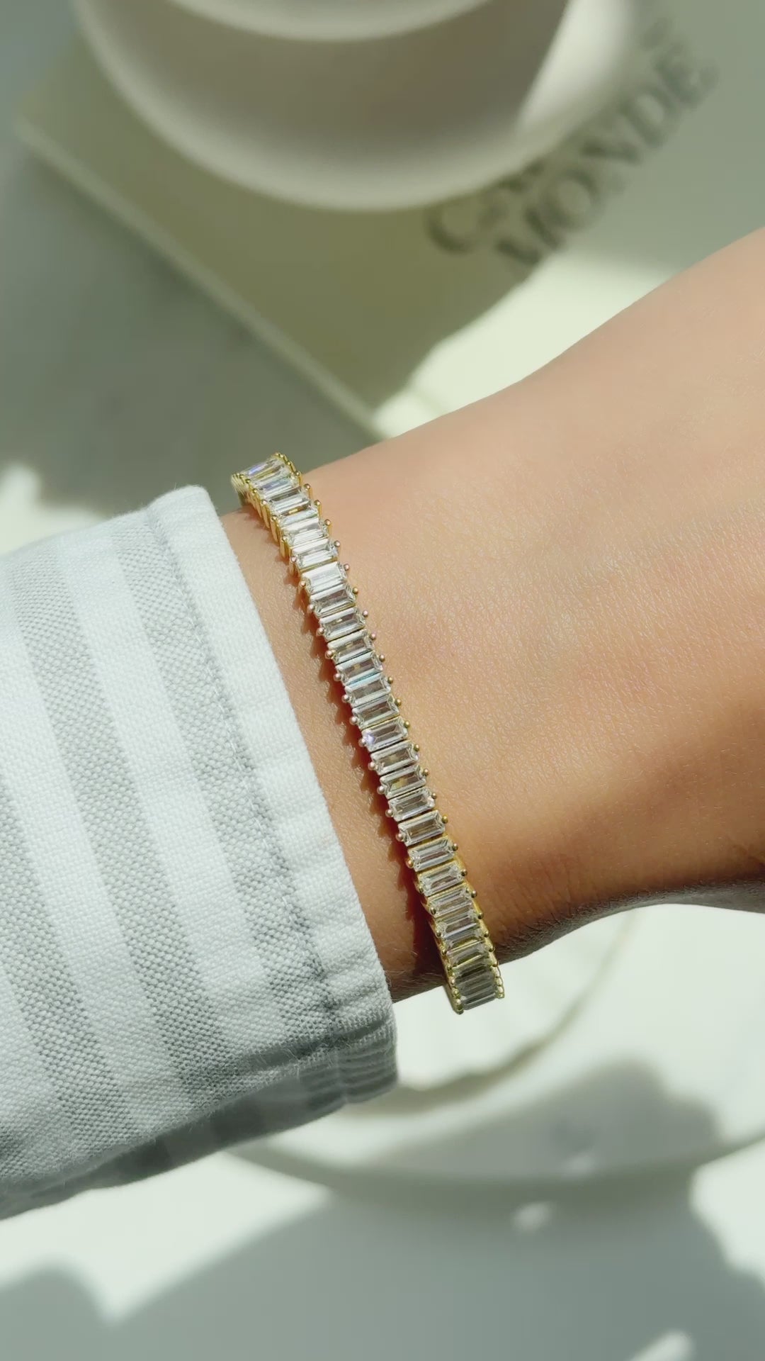 Model wearing gold baguette bracelet