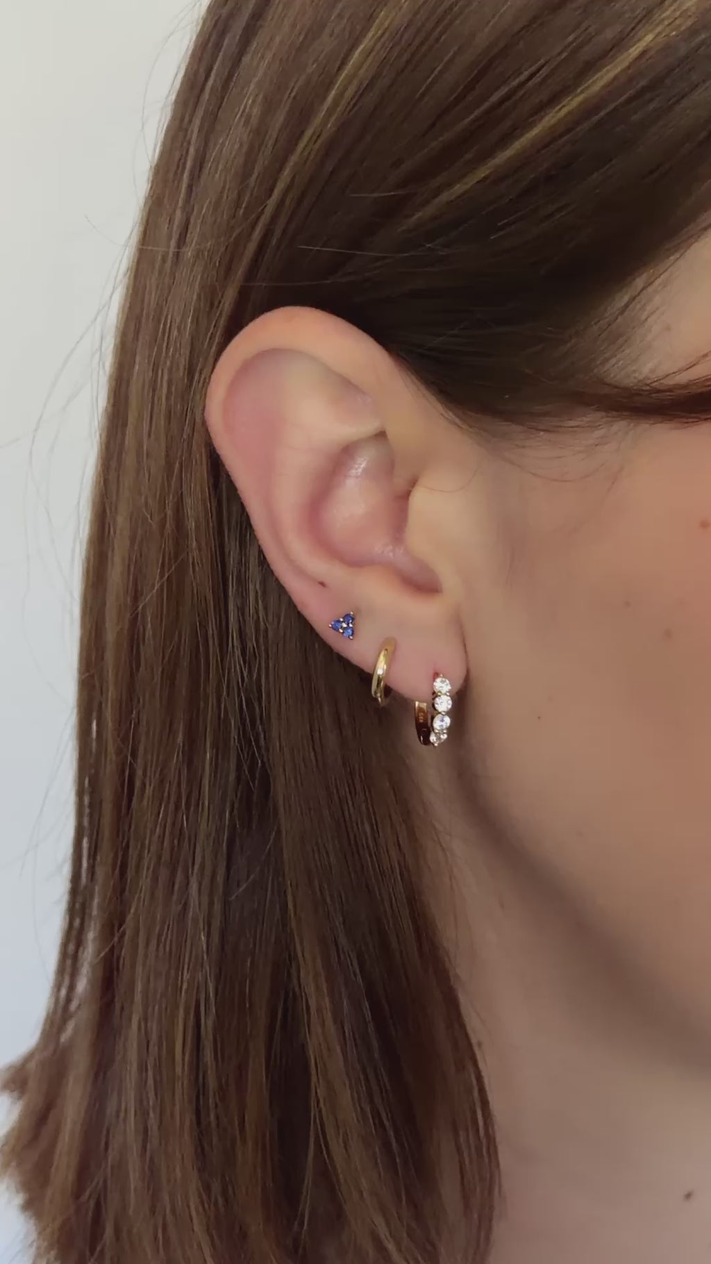 sapphire three stone earrings in gold in models third hole piercing in model video 