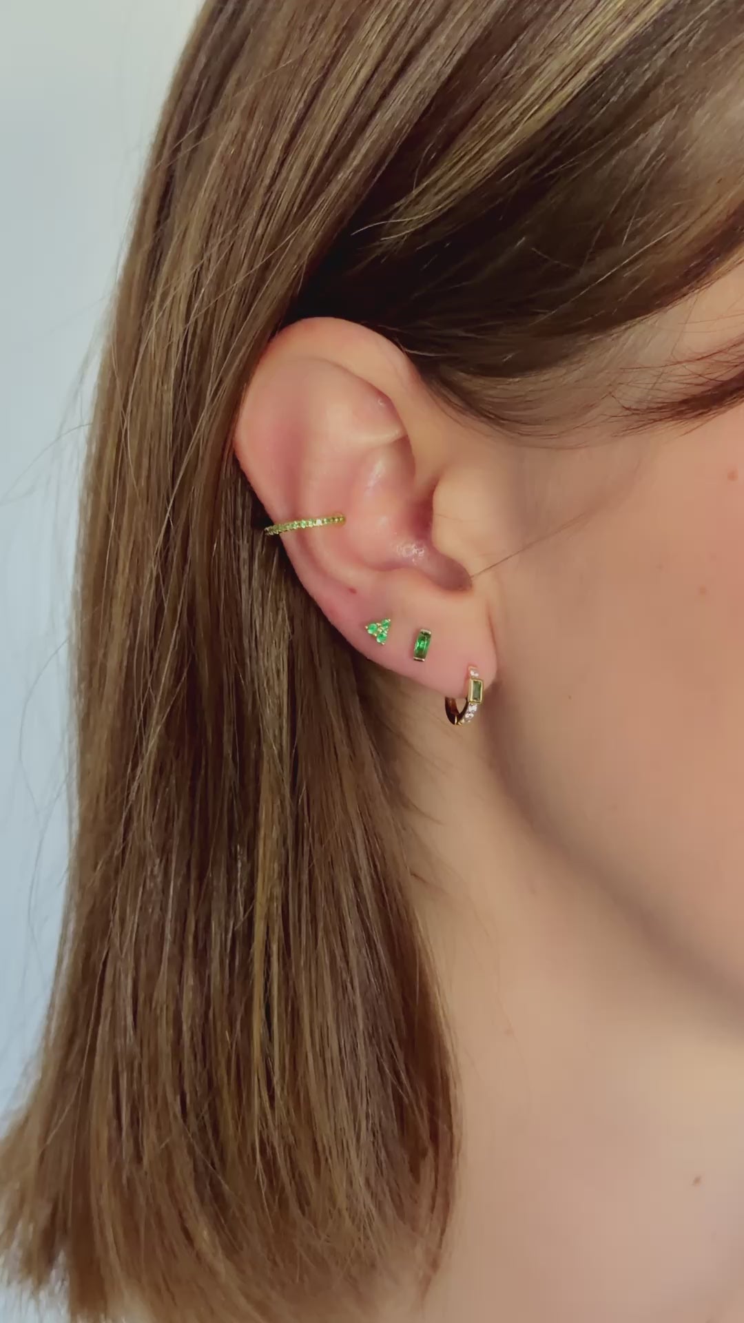 emerald baguette huggie earrings styled in gold on model video 