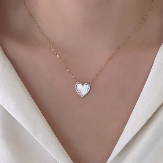 A model wearing the Mother of Pearl Necklace, styled with a white blouse. 