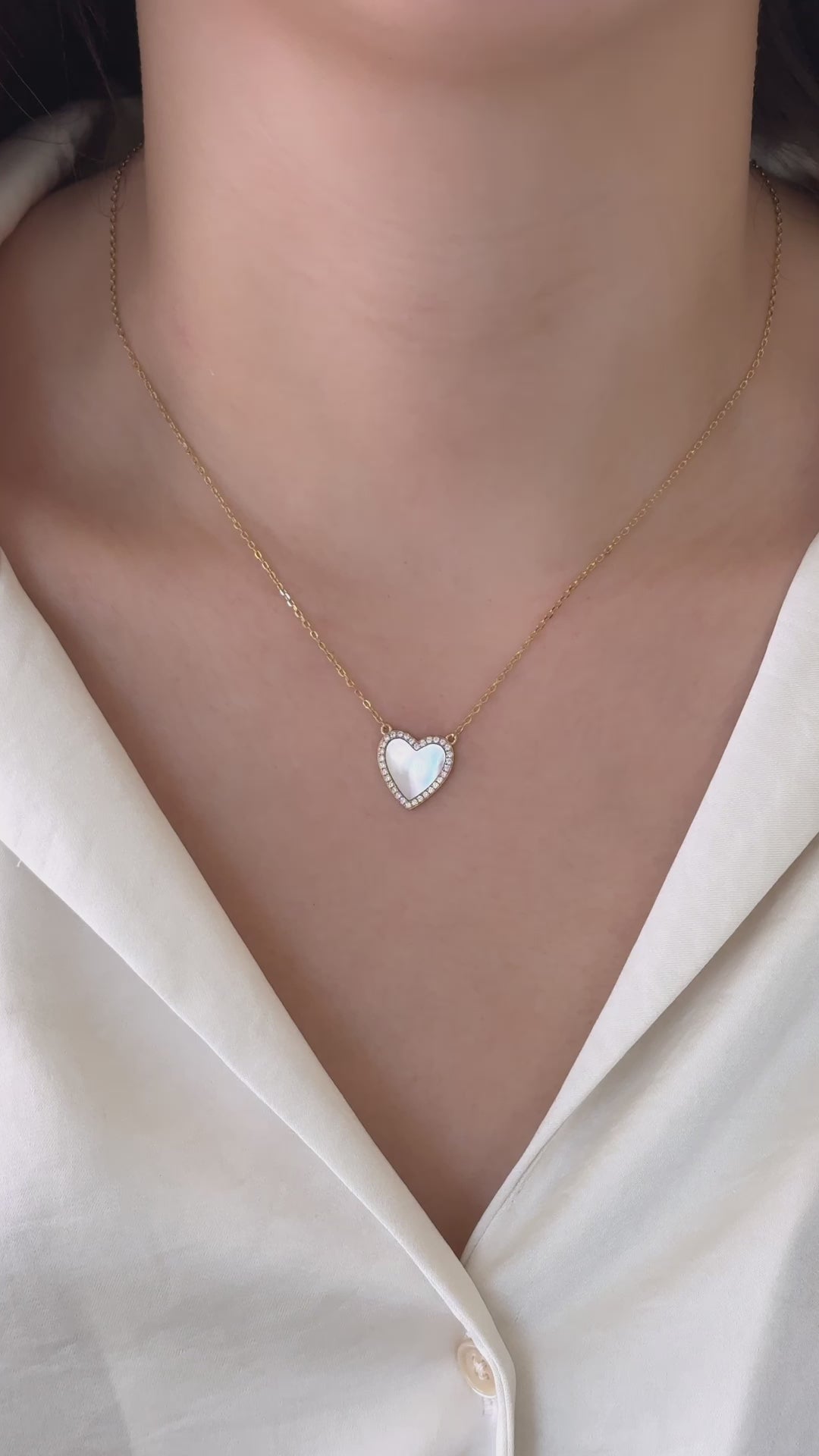 A model wearing the Mother of Pearl Necklace, styled with a white blouse. 