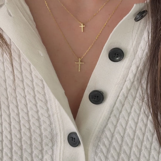 Video of model wearing simple plain gold cross necklaces from Sami Jewels