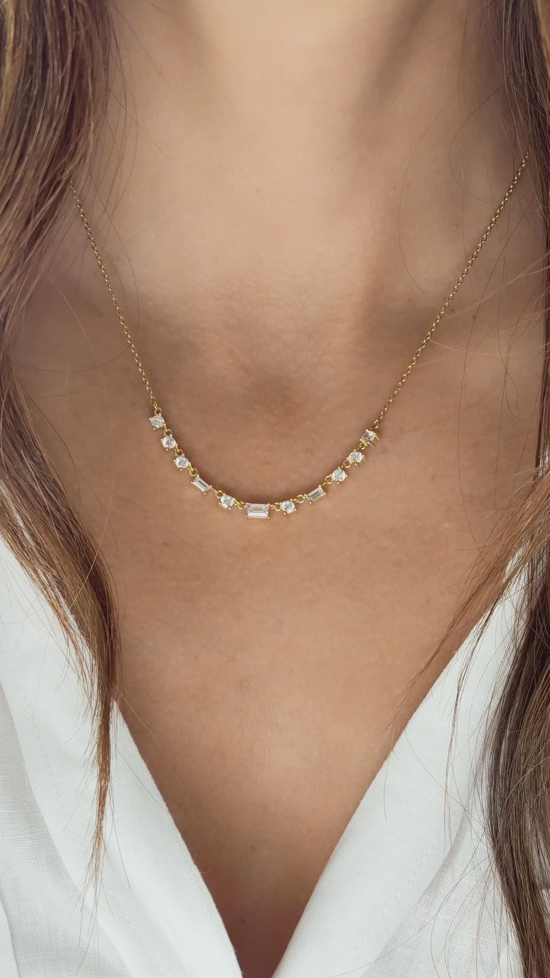 Model wearing simple gold baguette diamond necklace 
