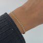 Video of model wearing gold chain layering bracelet from Sami Jewels