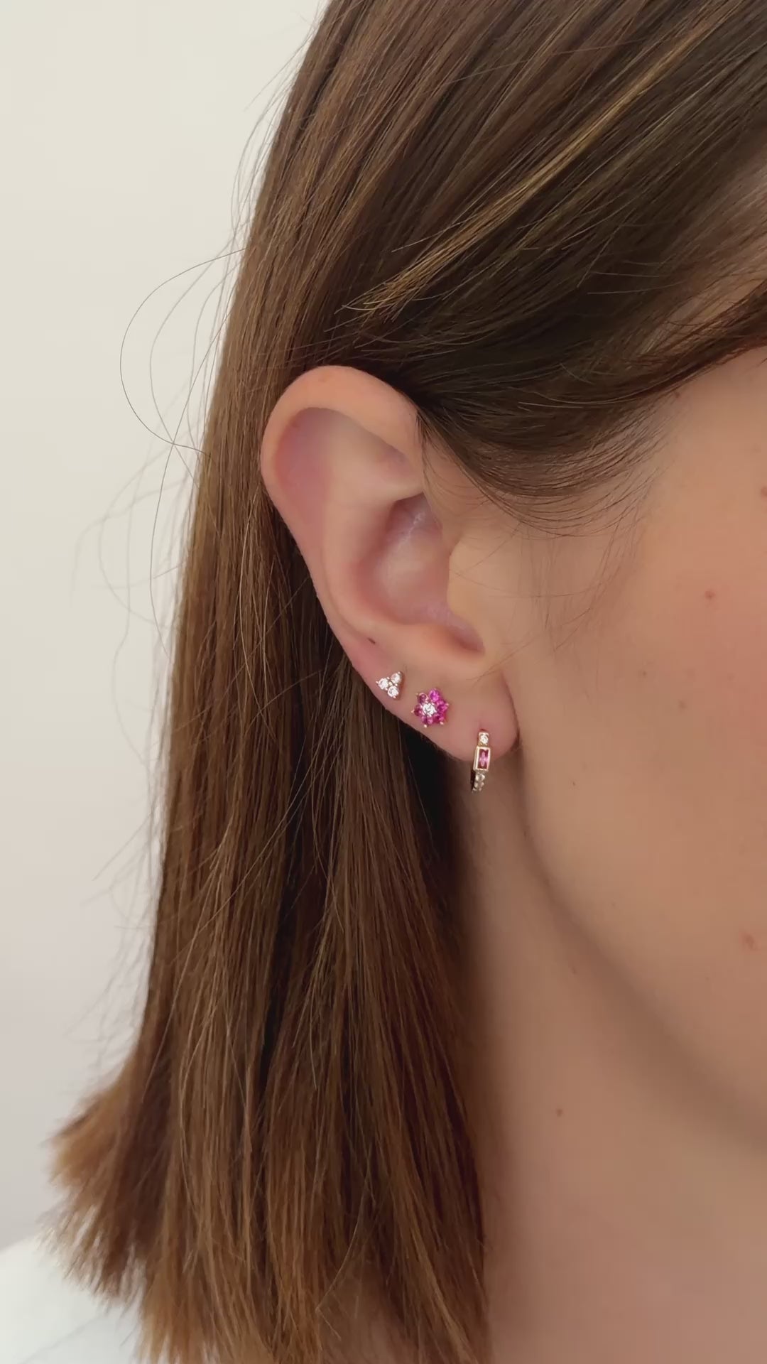 rose three stone stud earrings in gold earring stack styled on model video