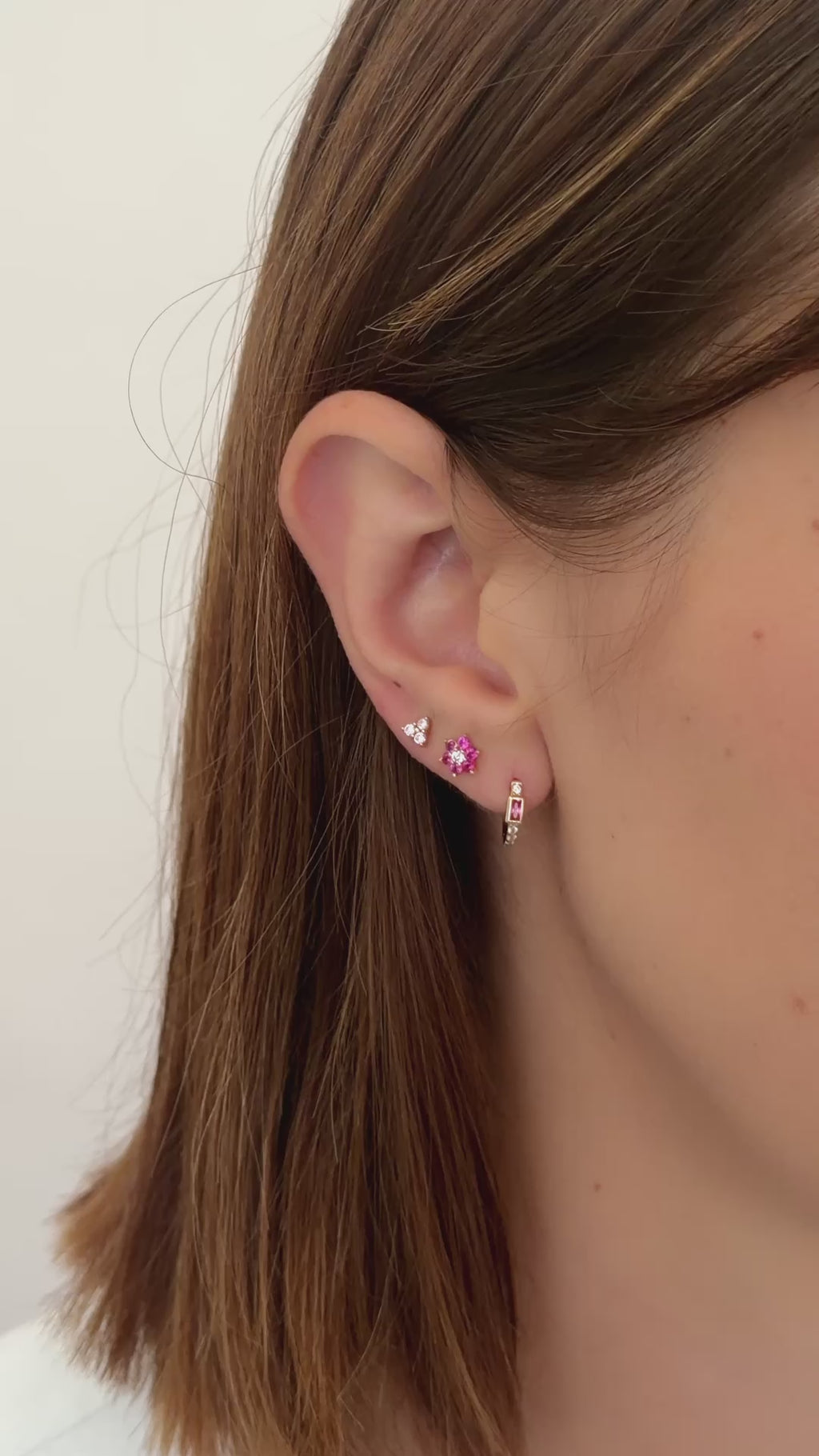 rose three stone stud earrings in gold earring stack styled on model video