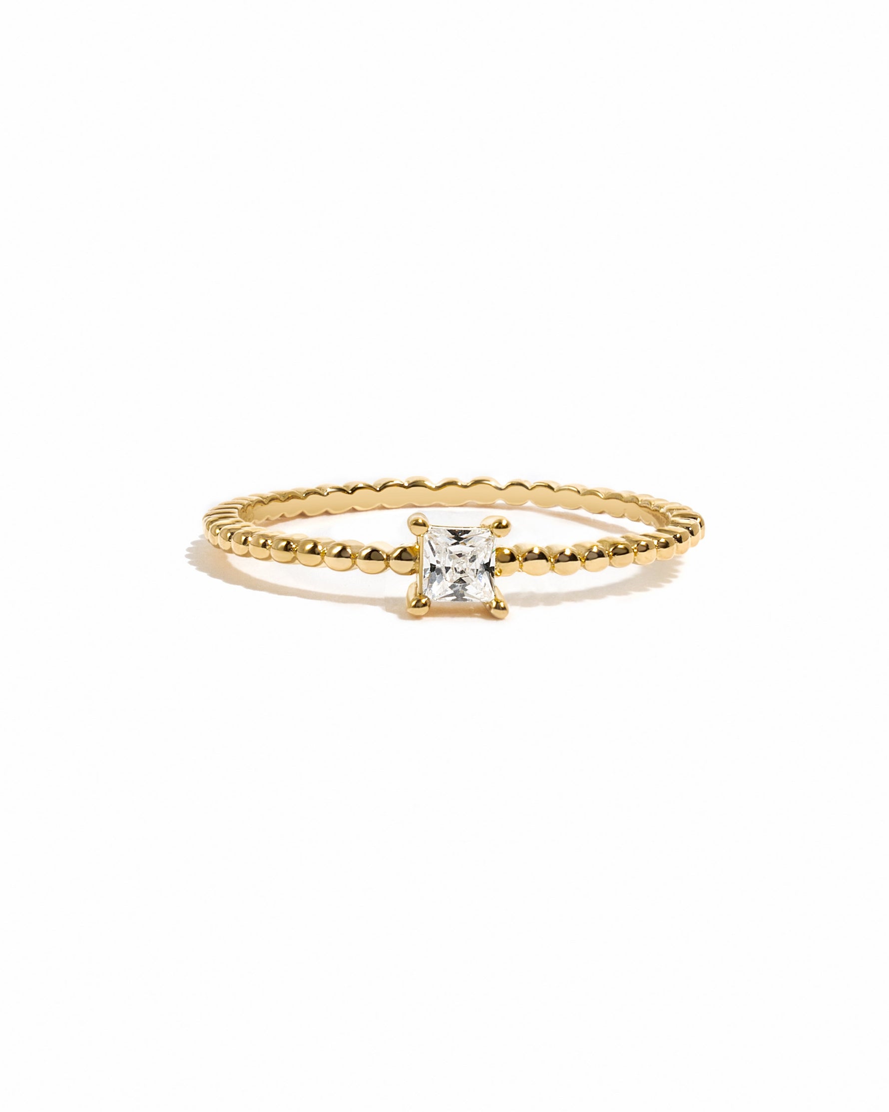 Gold princess cut ring with a beaded band from Sami Jewels displayed on a white background.