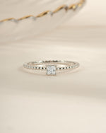 Sami Jewels princess cut ring with a beaded band in sterling silver, showcasing a sparkling princess-cut gemstone and detailed beaded design.