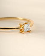 Close-up of Sami Jewels gold princess cut dainty ring showcasing a sparkling princess-cut gemstone and delicate band.